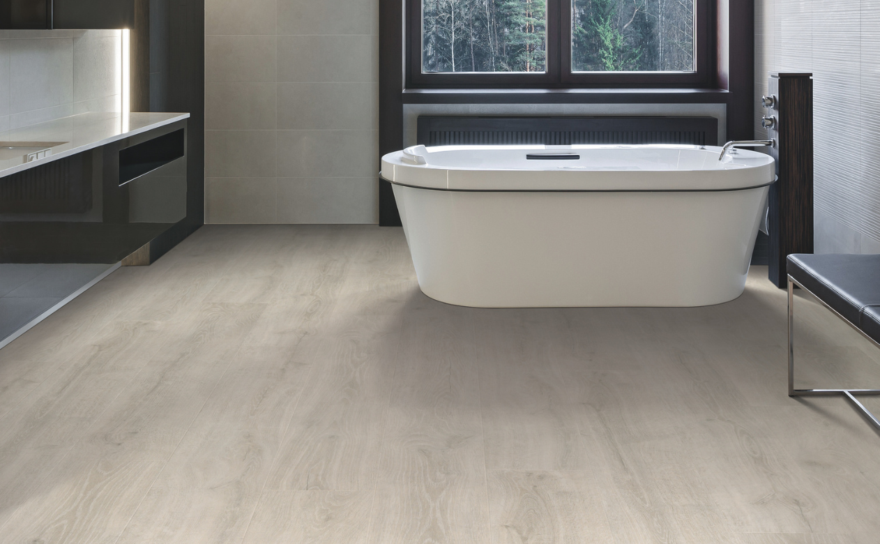 Wood-look laminate flooring in a bathroom with a bathtub