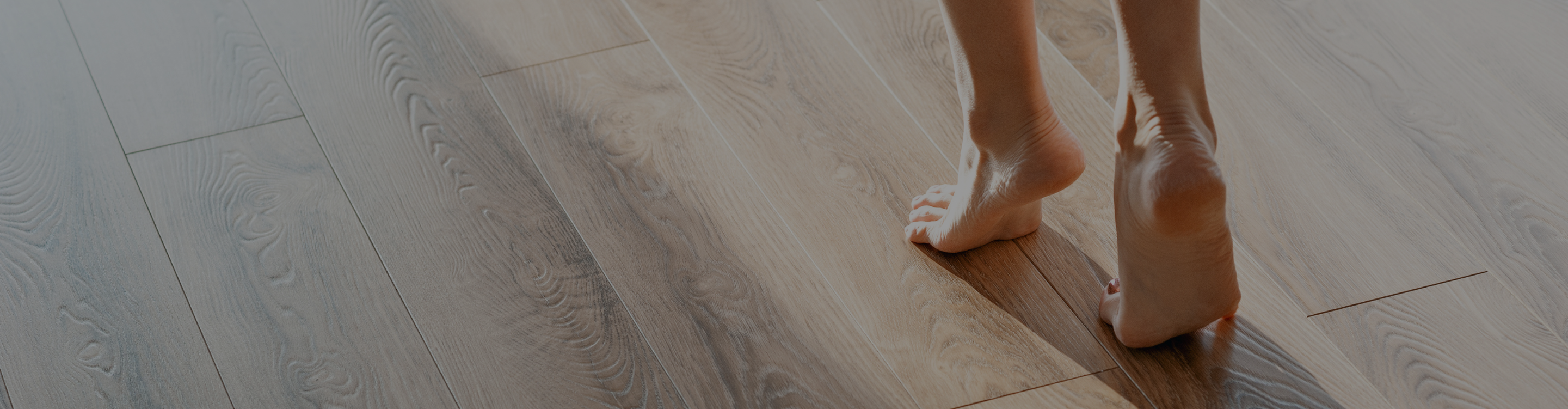 Bare feet on a wood floor. 